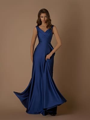 A woman stands against a plain background wearing the LAYLA NBM1030, a floor-length, sleeveless navy blue evening gown with a fitted bodice and a flared skirt. She holds part of the skirt with one hand, creating an elegant drape. Perfect for any occasion on the Sunshine Coast, this dress is available at your favorite dress store with Afterpay options. Angels Formal Wear