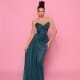 A woman wearing the elegant IZY NP149 teal strapless floor-length gown poses against a pink background. Her hair is styled in an updo, and she accessorizes with hoop earrings. The vibrant setting echoes the sunny vibes of Queensland’s Sunshine Coast. Angels Formal Wear