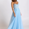 A woman poses in a light blue, strapless evening gown. The dress, from the HADLEY PO926 collection, features a fitted lace bodice with floral embellishments and a flowing tulle skirt. She has shoulder-length brown hair styled in loose waves and is standing against a plain white background. Angels Formal Wear