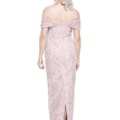 A woman with shoulder-length, wavy silver hair is wearing an off-shoulder ALIYA DRESS - TL1114 in light pink, floor-length with intricate beading and lace details. She is seen from the back, showcasing the ALIYA DRESS - TL1114's design and a small slit at the bottom. Angels Formal Wear